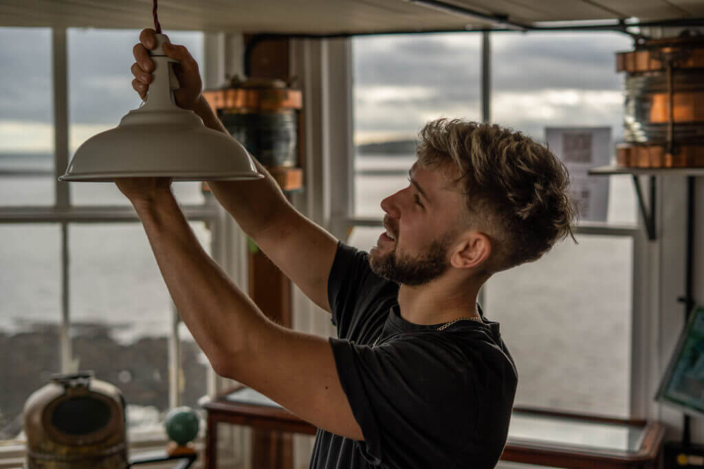 Matty from LS Electrical Services fixing a light fitting